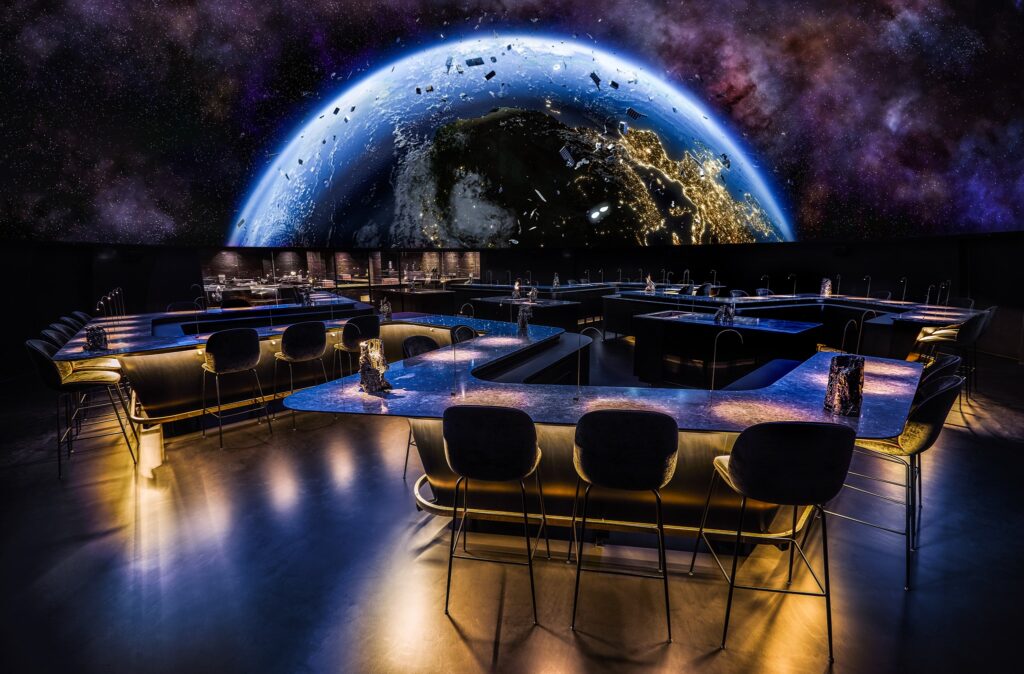 Gastronomy, theatre, art and spectacular visuals blend to create the Alchemist universe. A fine dining experience is the core of the restaurant – but keeping with the idea of Holistic Cuisine the servings are augmented by performers, installations and the architecture itself.
Most of the drama at Alchemist actually happens on the plates, where layers of subtext, both humorous and serious, line the 50 “impressions” that constitutes the Alchemist experience. Rasmus Munk’s gastronomy is Nordic at heart but far reaching in terms of inspiration and flavours.
